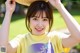 A young woman wearing a straw hat smiles at the camera.