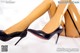 A pair of black high heels on a white surface.