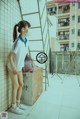 A woman wearing a face mask standing next to a ladder.